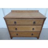 An oak chest of three graduated drawers.