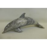 A large marble doorstop in the form of a dolphin.