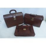 Two brown leather briefcases and a faux crocodile leather briefcase inscribed 'Mulberry'.
