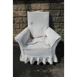 An Edwardian upholstered armchair.