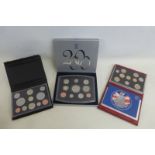 A cased Royal Mint 2000 proof set with booklet and two further proof sets from 2004 and 2008.