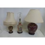 Three assorted Oriental table lamps with shades.