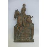 A brass fireside plaque depicting a gentleman on a horse jumping over a gate, numbered to reverse,