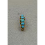An 18ct gold ring set with five turquoise stones.