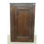 A small oak wall hanging corner cupboard.