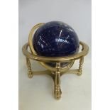 A table top globe made from precious stones.