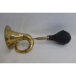 A decorative brass bulb horn.