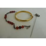 A Charles Horner hat pin, signed, an agate/amber bracelet and a yellow metal bangle with maker's