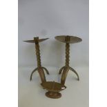 A pair of brass ecclesiastical candlesticks with barley twist columns to tripod bases; also a