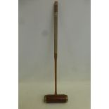 A Jacques of London mahogany and brass mounted croquet mallet.