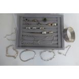 An assortment of silver and 9ct gold jewellery including rings, bracelets, a 9ct rose gold ring,