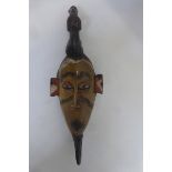 An unusual and early tribal mask, with patinated decoration.