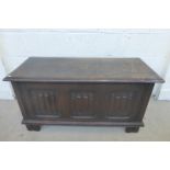 An oak coffer/blanket box with linenfold decoration to the panels.