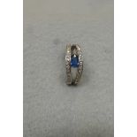 A white gold diamond and sapphire ring with accompanying receipt for £325 dated 2002.