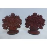 A pair of cast iron flower ornaments.