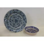 An 18th Century or earlier tin glazed charger and a Continental blue and white bowl.