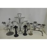 An assortment of candle stands including glass and metalware.