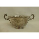 A large silver twin handled trophy, the handles in the form of dolphins, London 1906, maker