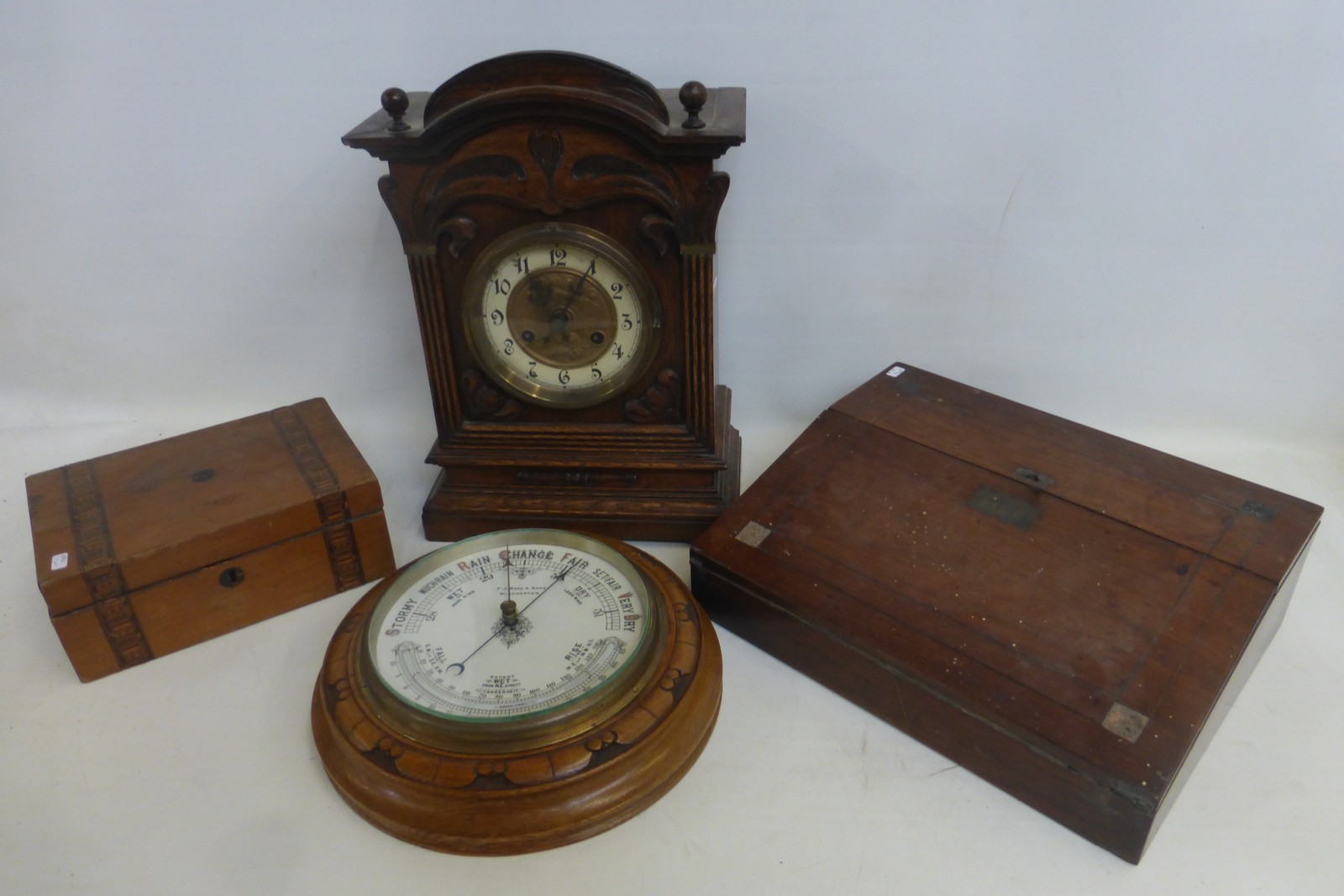An Edwardian oak cased mantle clock, an F.J. Ross & Sons of Winchester oak cased circular barometer,