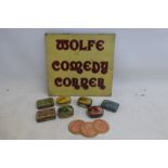 A small tin advertising sign for Wolfe Comedy Corner, 8 x 7 1/2" and a small quantity of needle