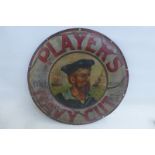 A Player's Navy Cut circular tin advertising sign depicting a sailor and two ships to the centre, 15