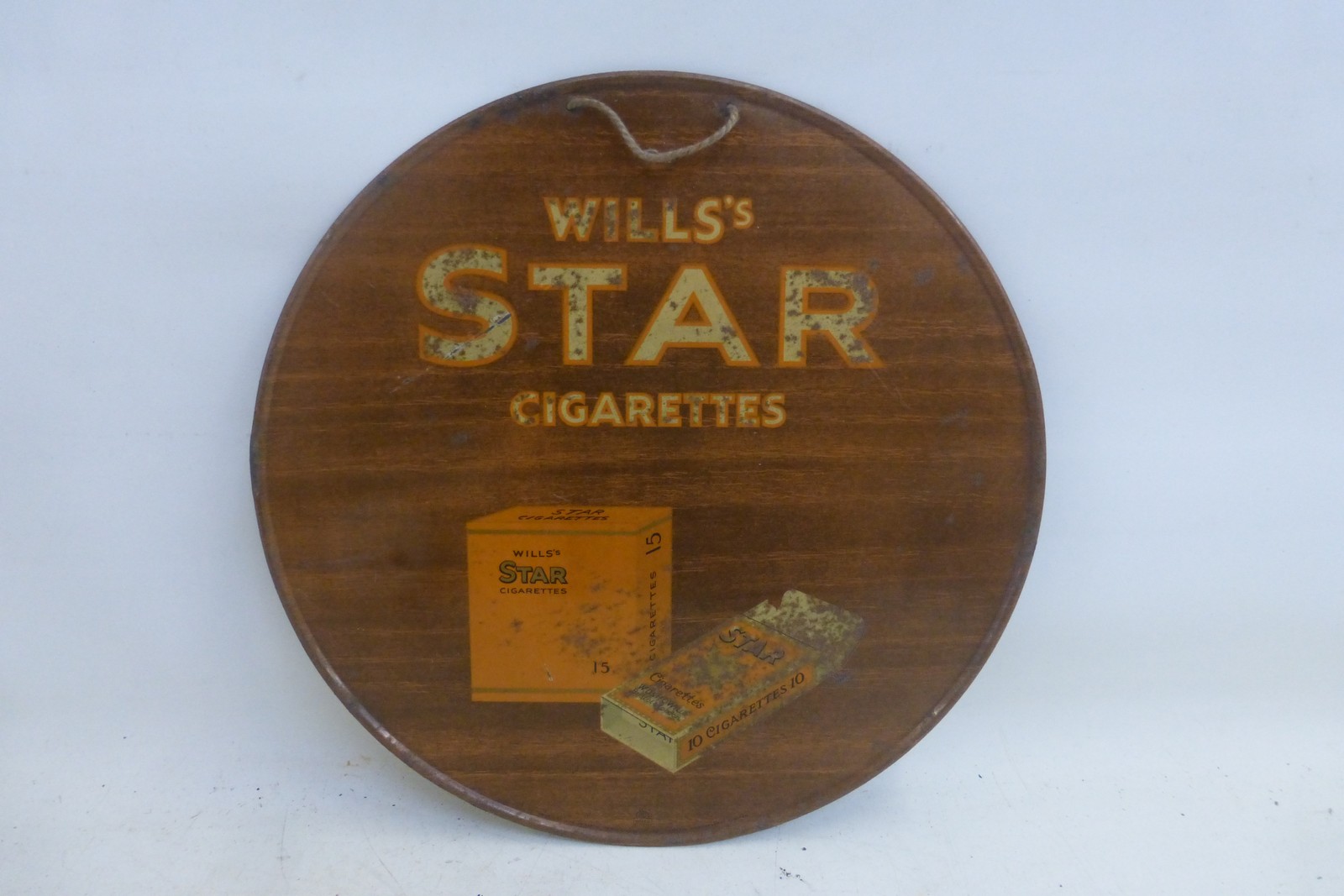 A Wills's Star Cigarettes pictorial packet tin advertising sign of circular form, 11 3/4" diameter.