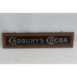 A Cadbury's Cocoa glass advertising sign within original frame, 18 x 4".