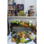 A collection of museum display fake fruit and vegetables, various household tins, chocolate boxes