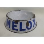 A Melox enamel dog bowl with a repair and restoration to the base of the bowl.