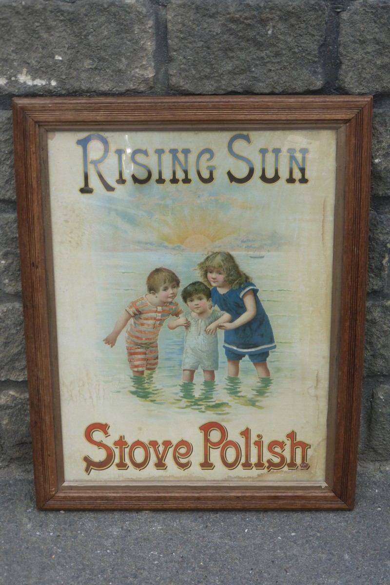 An oak framed and glazed "Rising Sun Stove Polish" pictorial showcard, 20 1/4 x 26".