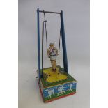 A Wyandotte Toys clockwork tinplate trapeze artist.