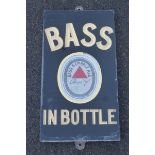 A Bass in Bottle slate brewery sign with oval enamel insert, by Dickson, 11 x 19 3/4".