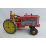 A part tinplate tractor, possibly Marx.