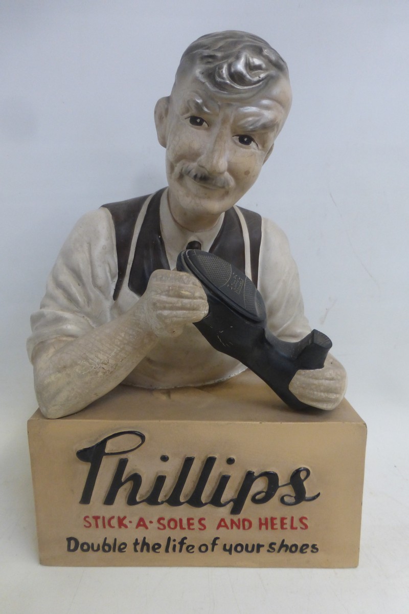 A Phillips Stick-a-Soles and Heels shop window advertising figure.