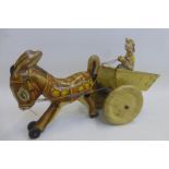 A Marx Toys clockwork tinplate model of a donkey pulling a cart with a figure inside.