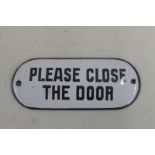 A 'Please close the door' shaped enamel door plate, 4 x 1 3/4".