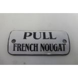 A "Pull French Nougat" convex enamel vending machine sign, 2 3/4 x 1 1/4".