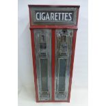 A wall mounted cigarettes two-section vending machine.