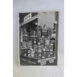 A black and white photograph of a 1930s shop window, full of radios.