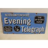 A Northamptonshire Evening Telegraph rectangular enamel sign with good gloss, 30 x 14 3/4".