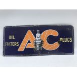 A small AC Plugs and Oil Filters rectangular enamel sign with central plug image, 21 x 9".