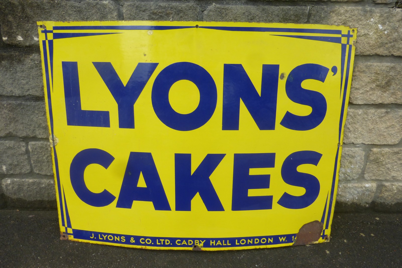 A Lyons' Cakes rectangular enamel sign, 39 x 29 1/2".