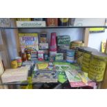 A shelf full of assorted packaging and tins mostly household products including herbs, spices,