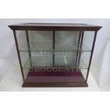 A large Cadbury's Chocolate counter top dispensing cabinet with two glass shelves and rear sliding