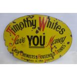 A Timothy Whites 'Save you money' oval enamel sign, 35 1/2 x 25".