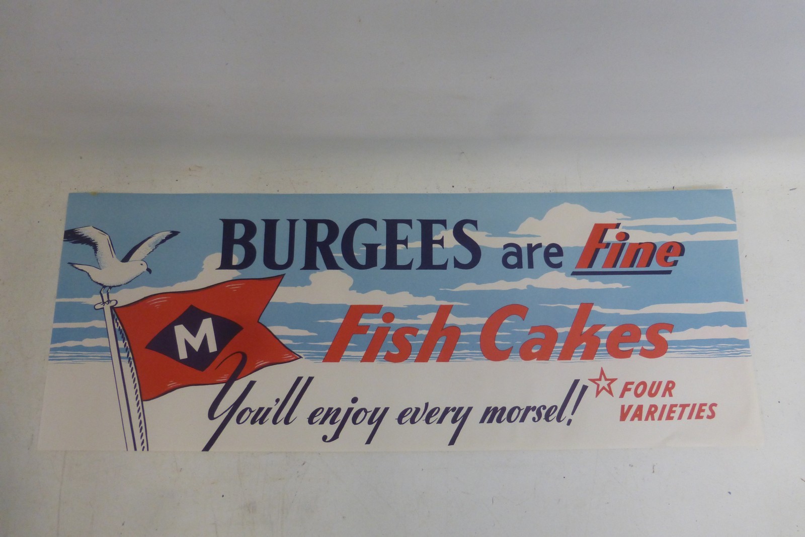 A Mudd's of Grimsby 'Burgees are fine fishcakes' rectangular window poster, 20 x 7 1/2".