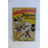 A rare Walt Disney Mickey Mouse pictorial tin advertising sign titled: Welcome Disneyland Jigsaw