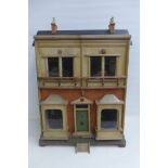 A Victorian front opening dolls house with assorted contents.