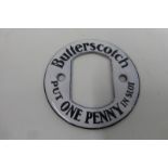 A small Butterscotch penny slot enamel sign frame, 2 1/4" diameter.