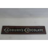 A Cadbury's Chocolate rectangular glass sign set within original frame, 23 x 4 1/2".